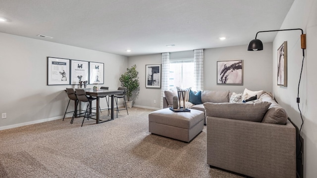 carpeted living room featuring a textured ceiling