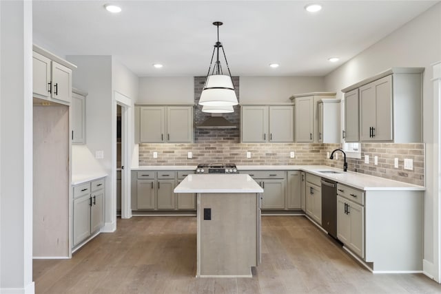 kitchen with stove, a center island, gray cabinets, and stainless steel dishwasher