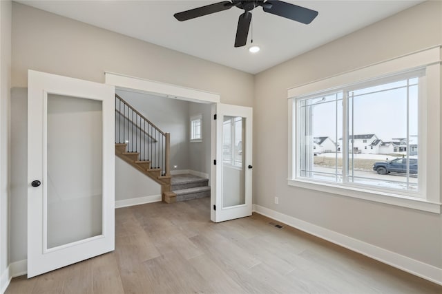 interior space with french doors, light hardwood / wood-style floors, and ceiling fan