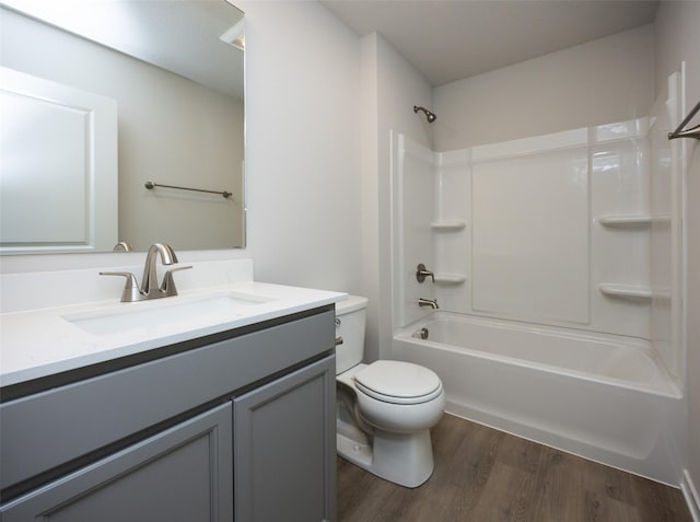 full bathroom featuring vanity, tub / shower combination, hardwood / wood-style floors, and toilet