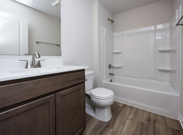 full bathroom featuring shower / tub combination, vanity, toilet, and hardwood / wood-style floors