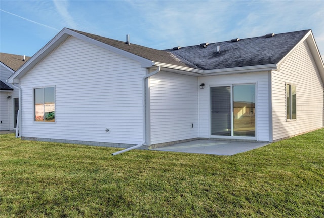 rear view of property with a patio area and a lawn