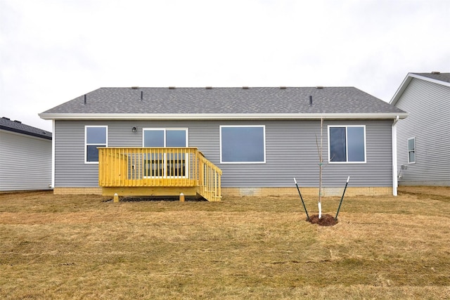 back of house featuring a lawn and a wooden deck