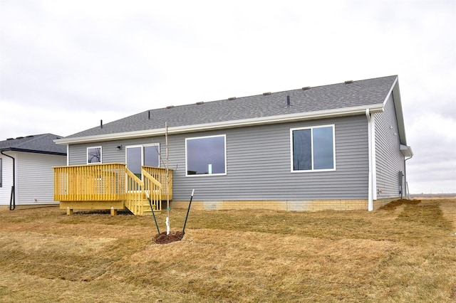 back of property with a wooden deck and a yard