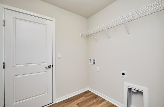 clothes washing area with hookup for an electric dryer, hookup for a washing machine, and wood-type flooring