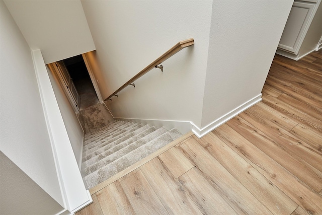 stairs featuring hardwood / wood-style floors