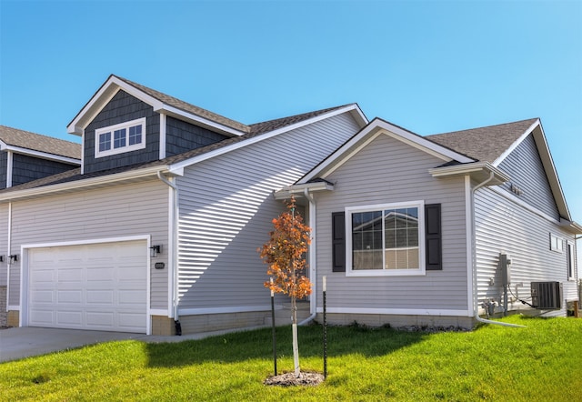 view of front of house with a front yard and central AC