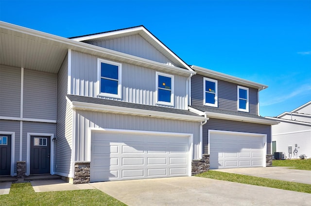 view of front of house featuring a garage and central AC unit