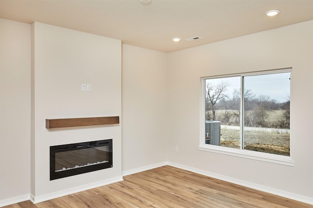 unfurnished living room featuring hardwood / wood-style floors