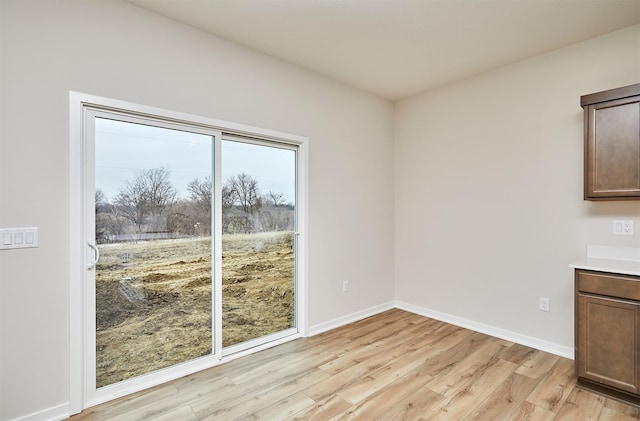 unfurnished dining area with light hardwood / wood-style flooring