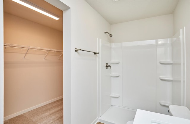 bathroom with toilet and walk in shower