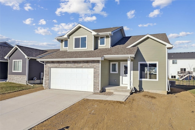 view of front of home with a garage and cooling unit