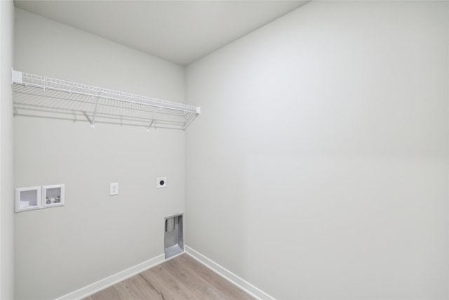 laundry area with hookup for an electric dryer, light wood-type flooring, and washer hookup