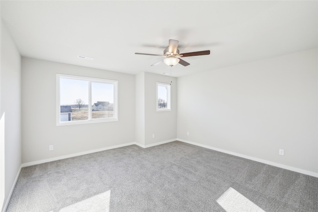 carpeted spare room featuring ceiling fan