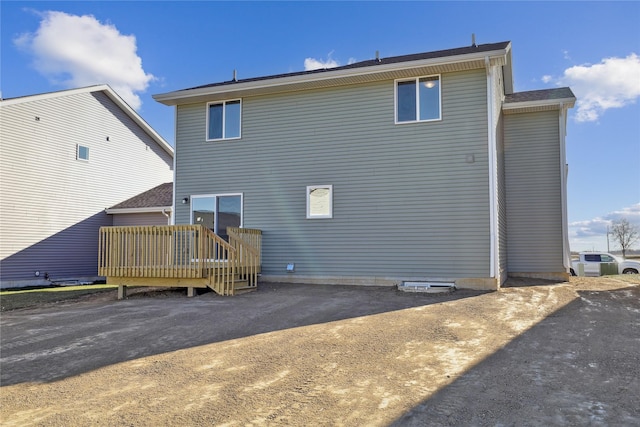 back of property with a wooden deck