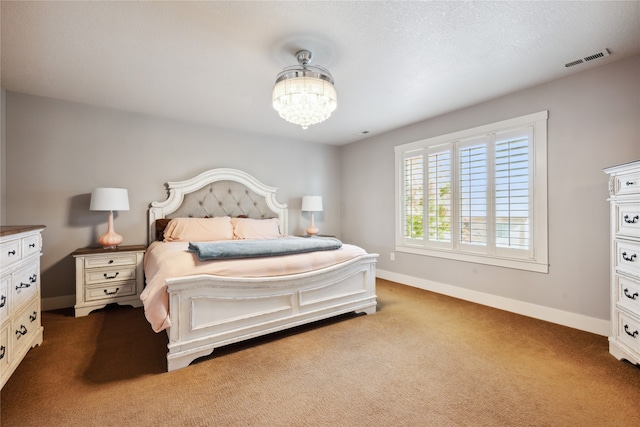 bedroom featuring a notable chandelier, carpet floors, visible vents, and baseboards