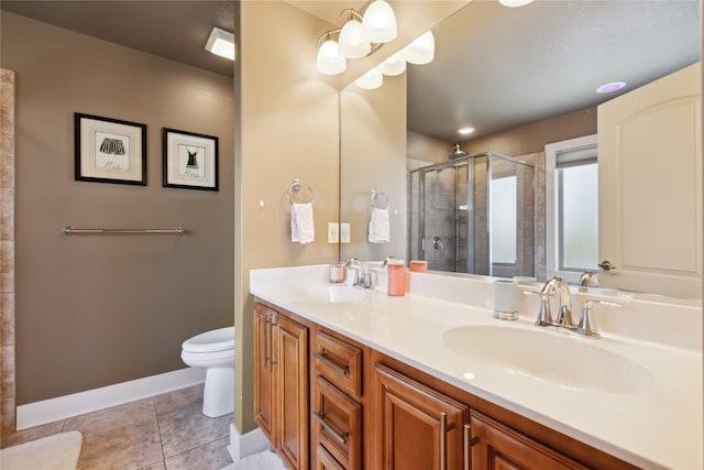 bathroom with double vanity, tile patterned flooring, a sink, and a shower stall