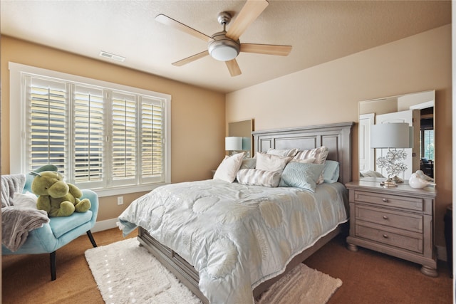 carpeted bedroom featuring baseboards, visible vents, and a ceiling fan