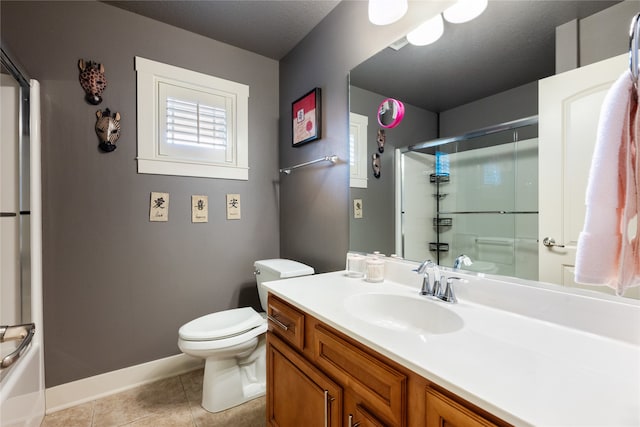 full bathroom featuring toilet, vanity, baseboards, and tile patterned floors