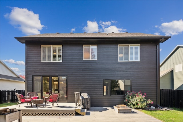 back of property with a deck, outdoor lounge area, and fence