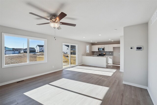 living room with hardwood / wood-style floors and ceiling fan