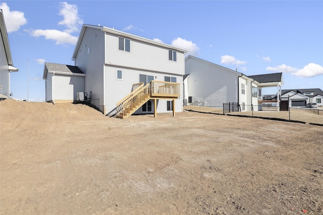 rear view of property featuring central AC and a wooden deck