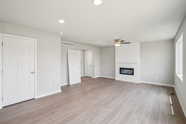 904 Spruce Ave, Norwalk, IA 50211 - unfurnished living room featuring ceiling fan, light wood finished floors, baseboards, a large fireplace, and recessed lighting