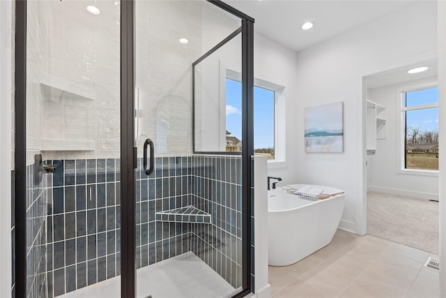 bathroom with tile patterned flooring and independent shower and bath