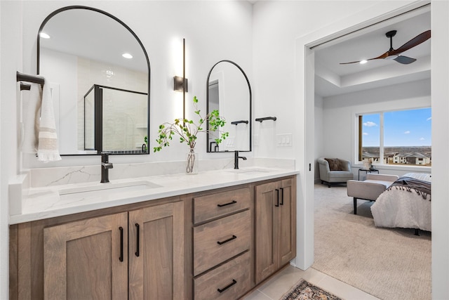 bathroom featuring tile patterned floors, ceiling fan, walk in shower, and vanity