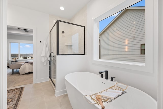 bathroom featuring tile patterned flooring and shower with separate bathtub