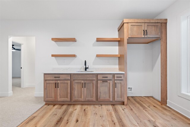 kitchen with ceiling fan, sink, and light carpet