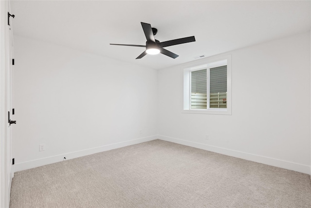 empty room with ceiling fan and light colored carpet