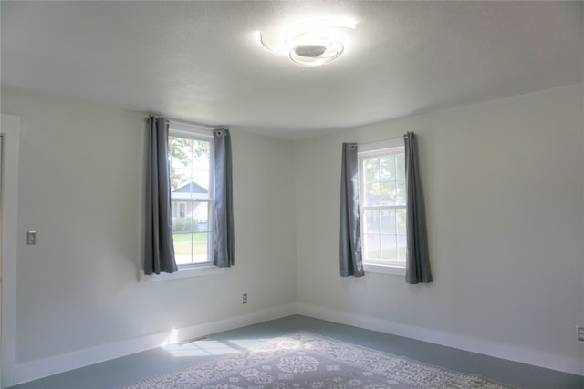 unfurnished room with a textured ceiling