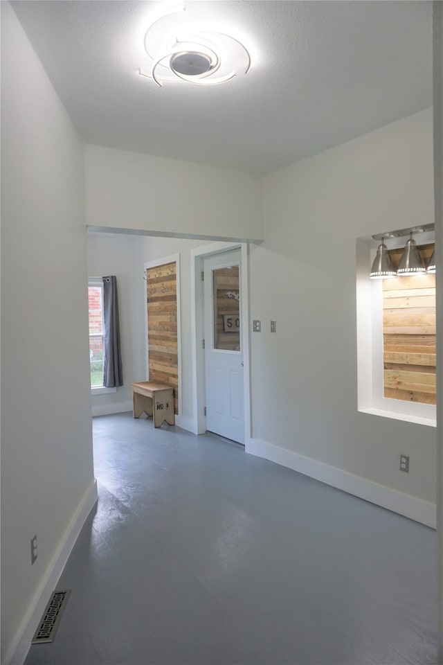 spare room featuring a textured ceiling and concrete flooring