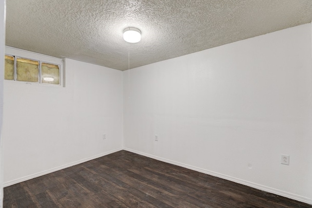 spare room featuring hardwood / wood-style flooring and a textured ceiling