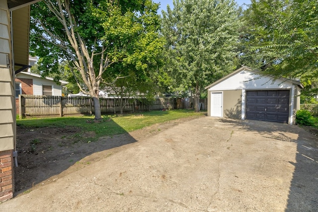 exterior space featuring a garage and an outbuilding