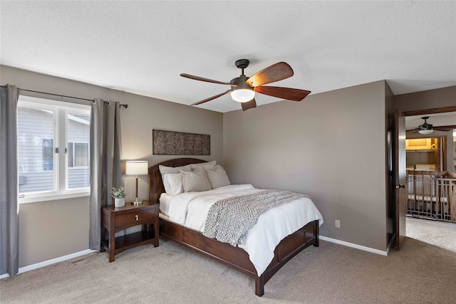 bedroom with a textured ceiling, ceiling fan, and carpet floors