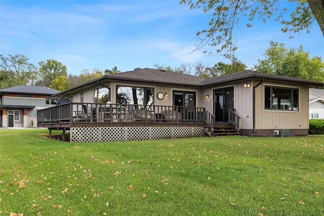 back of property featuring a lawn and a deck