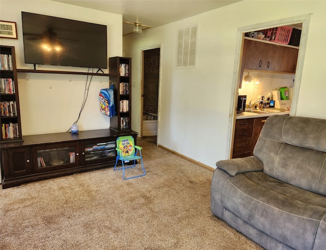 living room featuring built in desk and light colored carpet