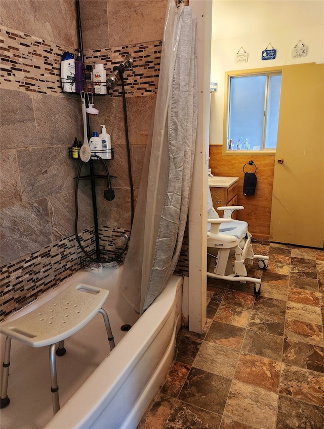 bathroom featuring shower / tub combo with curtain and tile walls