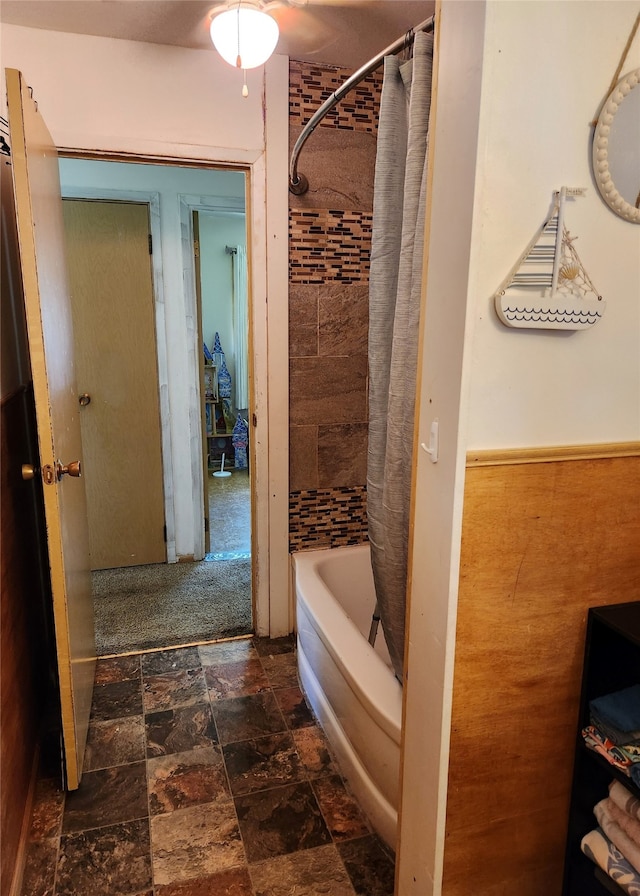 bathroom with shower / bath combo with shower curtain