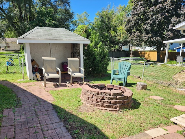 view of yard with an outdoor fire pit and a patio area