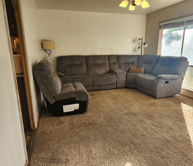 carpeted living room with ceiling fan