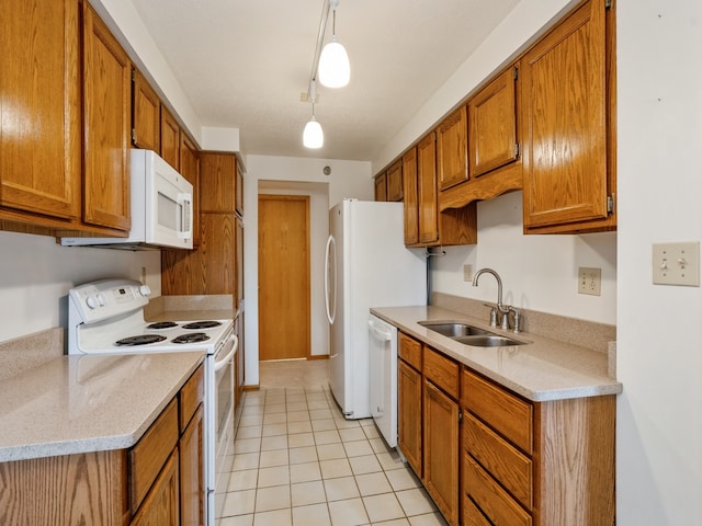 kitchen with pendant lighting, white appliances, light tile patterned floors, light stone counters, and sink