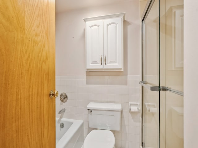 bathroom with tile walls, toilet, and separate shower and tub