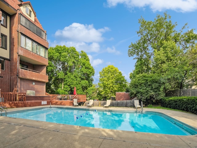 view of swimming pool with a deck