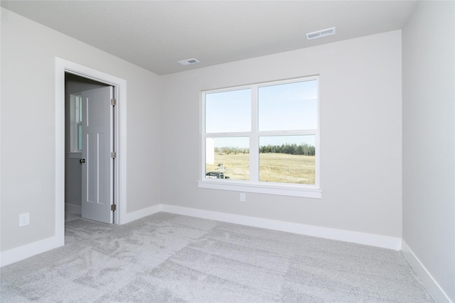 unfurnished room featuring light colored carpet