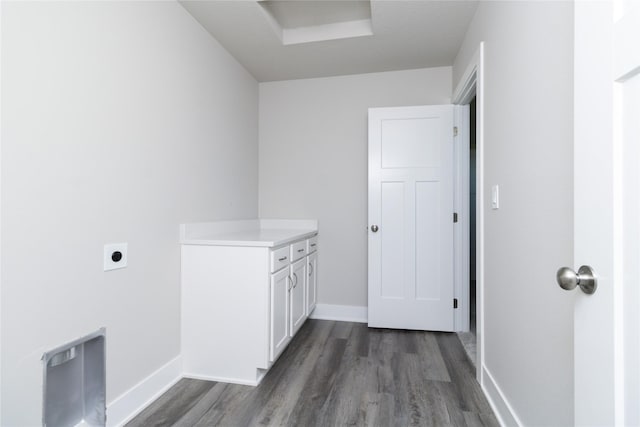 washroom featuring cabinets, dark hardwood / wood-style floors, and electric dryer hookup