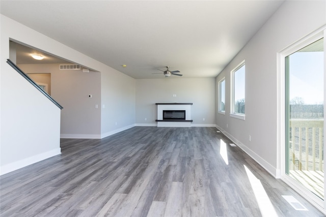 unfurnished living room featuring hardwood / wood-style floors and ceiling fan