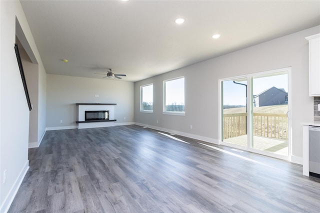 unfurnished living room featuring hardwood / wood-style flooring and ceiling fan